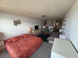 a bedroom with a bed and a living room at Cozy studio in Veytaux