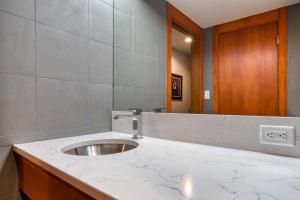a bathroom with a sink and a mirror at Lodge Room 005 in Black Butte Ranch