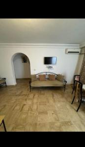 a living room with a couch and a flat screen tv at Appartement rez de jardin in Hammamet +2 photos