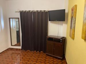 a room with a black curtain and a mirror at Sandy's in Morelia