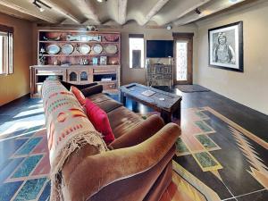 a living room with a couch and a table at Casita Mariposa in Santa Fe