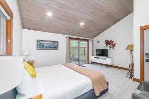 a bedroom with a large bed and a tv at Lodge Room 019 in Black Butte Ranch