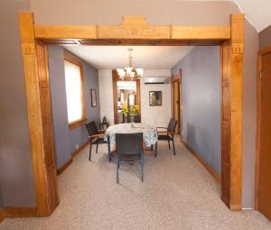 a dining room with a table and chairs at Wide River Winery Inn in Le Claire