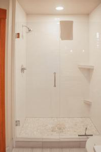 a shower with a glass door in a bathroom at Lodge Condo 014 in Black Butte Ranch +9 photos