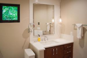 a bathroom with a sink and a mirror at Lodge Condo 014 in Black Butte Ranch