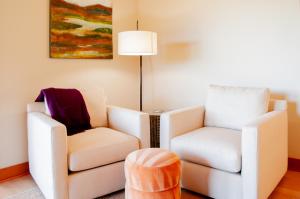 a living room with two chairs and a lamp at Lodge Condo 014 in Black Butte Ranch