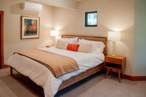 a bedroom with a large white bed with two lamps at Lodge Condo 014 in Black Butte Ranch