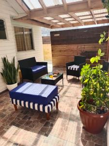 a patio with two chairs and a table at La Casita en Caldera in Caldera