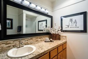 a bathroom with a sink and a large mirror at Golf Condo 081 in Black Butte Ranch