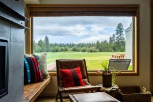 a window with a view of a golf course at Golf Condo 081 in Black Butte Ranch