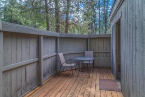 a patio with a table and chairs on a wooden deck at Lodge Room 019 in Black Butte Ranch