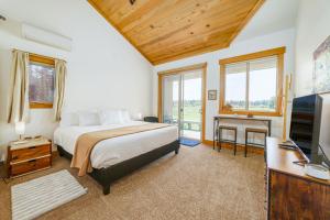a bedroom with a bed and a flat screen tv at Lodge Room 035 in Black Butte Ranch