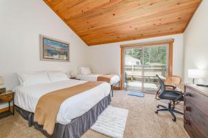 a bedroom with a bed and a desk and a window at Lodge Room 035 in Black Butte Ranch