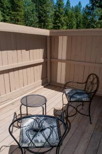 two chairs and a table on a deck at Lodge Room 016 in Black Butte Ranch