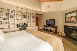 a bedroom with a large bed and a fireplace at Lodge Room 023 in Black Butte Ranch
