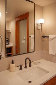 a bathroom with a sink and a large mirror at Lodge Room 015 in Black Butte Ranch