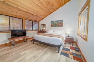 a bedroom with a bed and a flat screen tv at Lodge Condo 036 in Black Butte Ranch