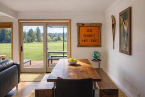 a living room with a wooden table and a sliding glass door at Golf Condo 081 in Black Butte Ranch
