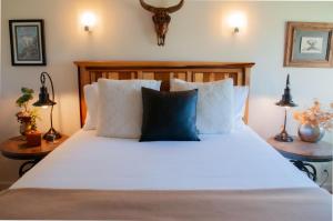 a bedroom with a large white bed with a blue pillow at Golf Condo 081 in Black Butte Ranch +9 photos