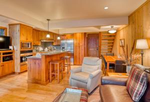 a kitchen with wooden cabinets and a living room at Country House 065 in Black Butte Ranch