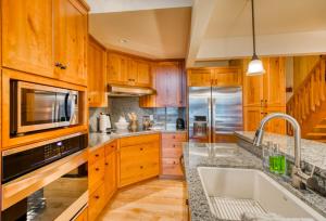 a kitchen with wooden cabinets and a sink at Country House 065 in Black Butte Ranch