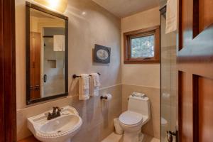 a bathroom with a sink and a toilet and a mirror at Country House 045 in Black Butte Ranch