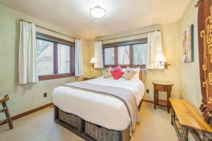 a bedroom with a large bed and windows at Country House 045 in Black Butte Ranch