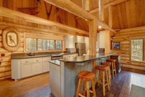 a kitchen with a large island in a log cabin at Golf Home 105 in Black Butte Ranch