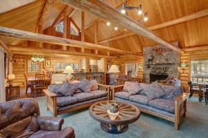 a living room with couches and a stone fireplace at Golf Home 105 in Black Butte Ranch