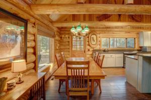 a dining room and kitchen in a log cabin at Golf Home 105 in Black Butte Ranch