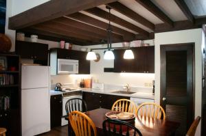 a kitchen with a table and chairs and a white refrigerator at Ridge Cabin 022 in Black Butte Ranch