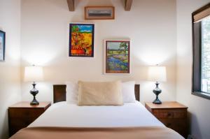 a bedroom with a white bed and two lamps at Ridge Cabin 022 in Black Butte Ranch +17 photos