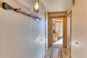 a hallway with a light fixture on the wall at Lodge Room 002 in Black Butte Ranch