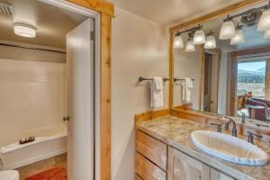 a bathroom with a sink and a mirror at Lodge Room 002 in Black Butte Ranch