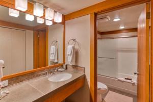 a bathroom with a sink and a toilet and a mirror at Lodge Room 023 in Black Butte Ranch