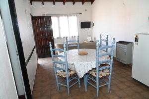 a kitchen with a table and chairs in a room at Como en casa in Rawson +2 photos