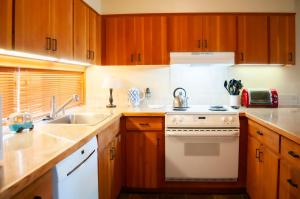 a kitchen with wooden cabinets and a stove and a sink at Golf Condo 095 in Black Butte Ranch