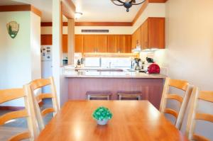a kitchen with a wooden table with a potted plant on it at Golf Condo 095 in Black Butte Ranch