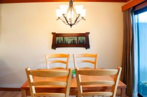 a dining room table with two chairs and a mirror at Golf Condo 095 in Black Butte Ranch