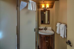 a bathroom with a sink and a shower with a mirror at Golf Condo 095 in Black Butte Ranch +8 photos