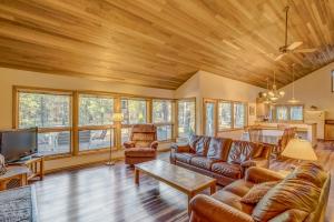 a living room with leather furniture and a wooden ceiling at East Meadow 017 in Black Butte Ranch