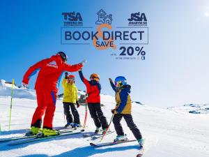 a group of people on skis in the snow at Cedar Creek 3 in Thredbo