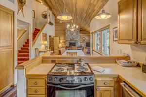 a kitchen with a stove and a living room at East Meadow 017 in Black Butte Ranch