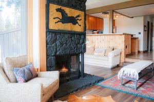a living room with a fireplace with two chairs at Country House 071 in Black Butte Ranch