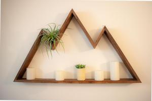 a wooden frame with candles and plants on a wall at Country House 071 in Black Butte Ranch +9 photos