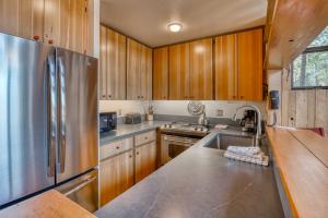 a kitchen with wooden cabinets and a stainless steel refrigerator at Country House 073 in Black Butte Ranch