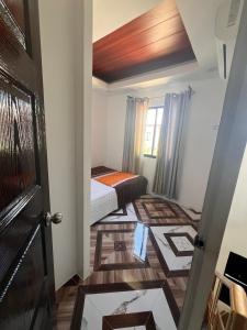 a small room with a bed and a door at JO's HOMEtel SL 1 in Sampong +2 photos