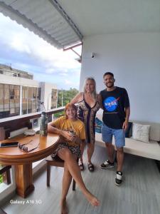 a group of people posing for a picture on a balcony at Marina Suite in Puerto Ayora