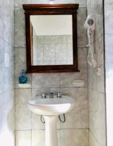 a bathroom with a white sink and a mirror at El Aromo Cafayate in Cafayate +24 photos