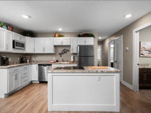 a kitchen with white cabinets and a counter top at TC Parkside G: Spacious 2BR Condo in Traverse City